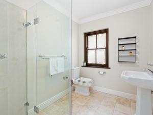 a bathroom with a shower and a toilet and a sink at Winelands Golf Lodges 2 in Stellenbosch +50 photos