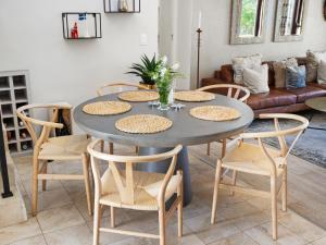 a dining room with a table and chairs at Winelands Golf Lodges 2 in Stellenbosch
