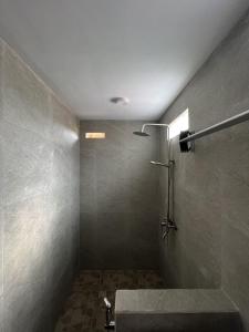 a bathroom with a shower and a sink at Lumbung Kembar Guest House, Nyanyi in Munggu +3 photos