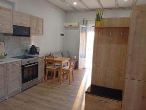 a kitchen with a table and a dining room at Stavros luxury studio in Antipernoí