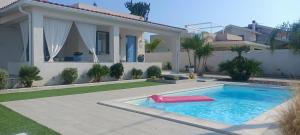 a swimming pool with a slide in a yard at Villa Colapesce in Marzamemi