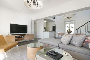 a living room with a couch and a tv at Winelands Golf Lodges 3 in Stellenbosch