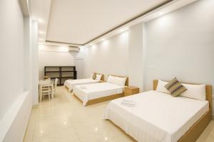 Postel nebo postele na pokoji v ubytování Eco Nest Hotel Đình Ngang