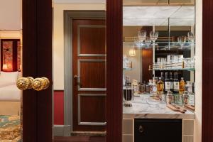 a bar with a counter with bottles of alcohol at Maxwell Reserve Singapore, Autograph Collection in Singapore