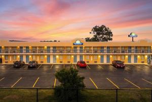 a hotel with cars parked in a parking lot at Days Inn by Wyndham Fort Wayne in Fort Wayne