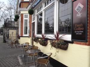 a row of tables and chairs outside of a coffee shop at The Stag Enfield in Enfield