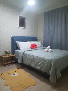 a bedroom with a blue bed and a rug at Putatan Platinium 2 Bedroom - Farah Biz Homestay in Putatan +4 photos