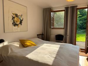 a bedroom with a bed and a window at Atelier-Turm in Gschwend