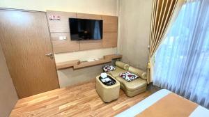 a hotel room with a bed and a tv at Hotel Pondok Asri Boyolali in Boyolali