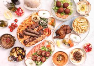 a table with many plates of food on it at InterContinental Bangkok by IHG in Bangkok