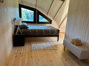 a bedroom with a bed and a window in a room at Lake House Denderi in Rubene