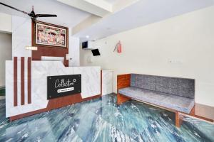 a room with two benches and a sign on the wall at Collection O MVP Double Road in Visakhapatnam