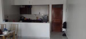 a kitchen with a counter and a table in a room at Kisimani Heights Nest in Mombasa