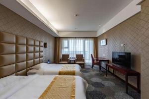a hotel room with two beds and a flat screen tv at Beijing Qiaobo International Conference Hotel in Beijing