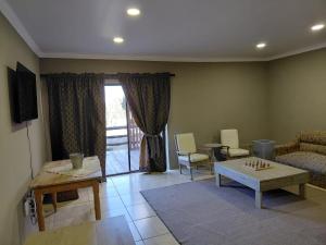 a living room with a couch and a table at Gratia Guest Accommodation in Reitz