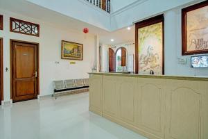 a large room with a counter and a door at OYO 92990 Nena Kostel Syariah in Padang