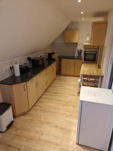 a kitchen with wooden cabinets and a counter top at Ferienwohnung in Kleinstadt nähe Spreewald in Luckau