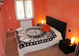 a bedroom with a black and white bed with orange walls at B&B Ca dei Fre in Genoa +15 photos