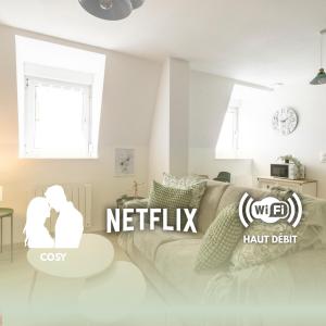 a living room with a couch and a table at MonSéjourCosy - Le Cottage - Studio - Cosy - Netflix in Mulhouse
