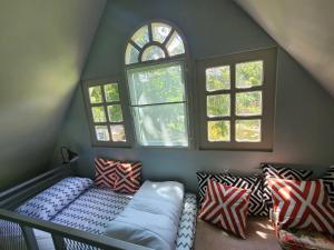 a room with a couch and some windows at บ้านสวนปรีดา-Preda Garden Home in Sam Phran