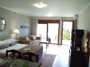 a living room with a bed and a couch at Villa Adelais App in Tsoukaladhes