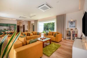 a living room with couches and a table at Le Jardin - Luxury Private Pool Villa near Kochi, Kerala in Cochin