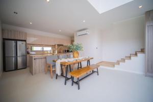 a kitchen and dining room with a table and chairs at 3BR Villa Z by NLA in Ban Pak Lak