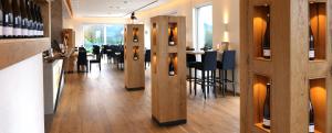 a restaurant with a bar with tables and chairs at Vögelis WeinNest in Landau in der Pfalz