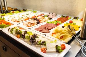 a buffet line with many different types of food at Abrazo Sofia Hotel by HMG in Sofia +120 photos