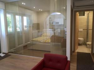 a room with a red chair and a glass window at Apartments & Rooms Marina in Dramalj +63 photos
