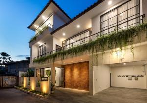 an exterior view of a house at night at Beach8 Canggu By Kerta Living in Canggu
