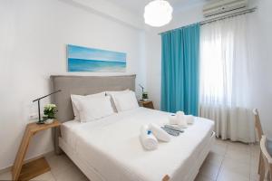 a bedroom with a bed with towels on it at Georgia apartments and suites in town in Skiathos