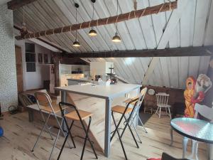 a kitchen and dining room with a table and chairs at Lägenhet-vindsvåning i centrala öregrund in Öregrund +4 photos
