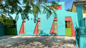 a colorful building with the wordoat painted on it at Suítes Recanto Renascer in Caraguatatuba