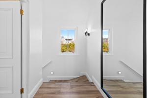 a white hallway with a glass door and two windows at Winelands Golf Lodges 28 in Stellenbosch +61 photos