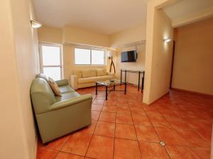 a living room with a couch and a table at Alcazar Suites in Guadalajara