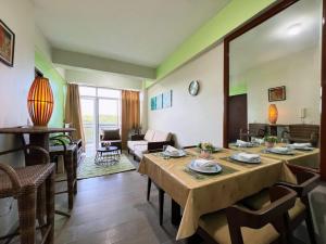 a living room with a table and a couch at Sharon's Island - Newcoast Boracay in Boracay