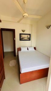 a bedroom with a large bed with white sheets at Salt Breeze sea view Apartment Mount Lavinia in Mount Lavinia