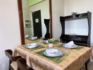 a dining room table with a table cloth and a mirror at Sharon's Island - Newcoast Boracay in Boracay