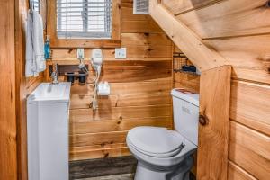 a bathroom with a toilet and a sink at Sojourn Lodging in Sevierville +92 photos