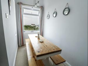 a wooden table in a room with a window at Lady of the Lake Suite in Holyhead