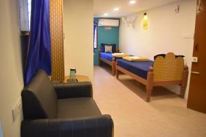 Postel nebo postele na pokoji v ubytování Aishwaryam home stay
