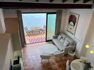a living room with a couch and a table at Oliva Lofts & Beach in Oliva