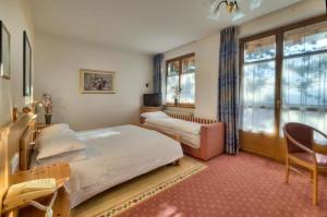 Postel nebo postele na pokoji v ubytování Hotel Waldheim Belvedere