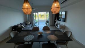 a living room with a dining room table with chairs at Departamento TerraMar Flamingos in Nuevo Vallarta