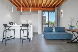 Mirtina Home - by And service في Casa Tamponi: مطبخ وغرفة معيشة مع طاولة وكراسي