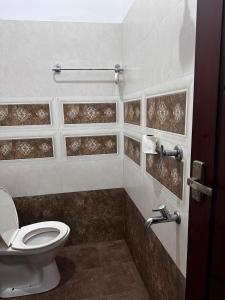 a bathroom with a toilet and a sink at Yatri Haven Varkala in Varkala