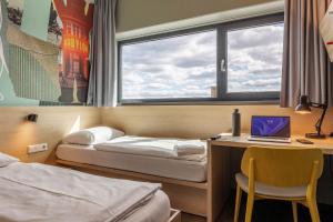 Postel nebo postele na pokoji v ubytování MEININGER Hotel Berlin Airport