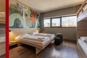 Postel nebo postele na pokoji v ubytování MEININGER Hotel Berlin Airport