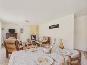 a living room with a table and chairs at Maison de plain-pied pour 4 - jardin et terrasse in La Forêt-Fouesnant